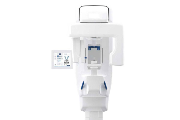 A white panoramic dental x ray machine with a side screen of small images of a dental treatment plan